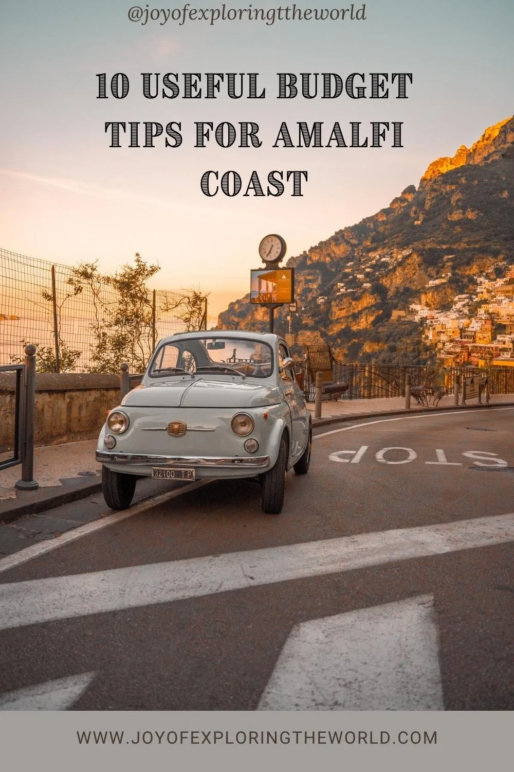 Amalfi on a budget tips - Vintage Fiat parked on a coastal road at sunset with Amalfi Coast cliffs and colourful houses in the background.