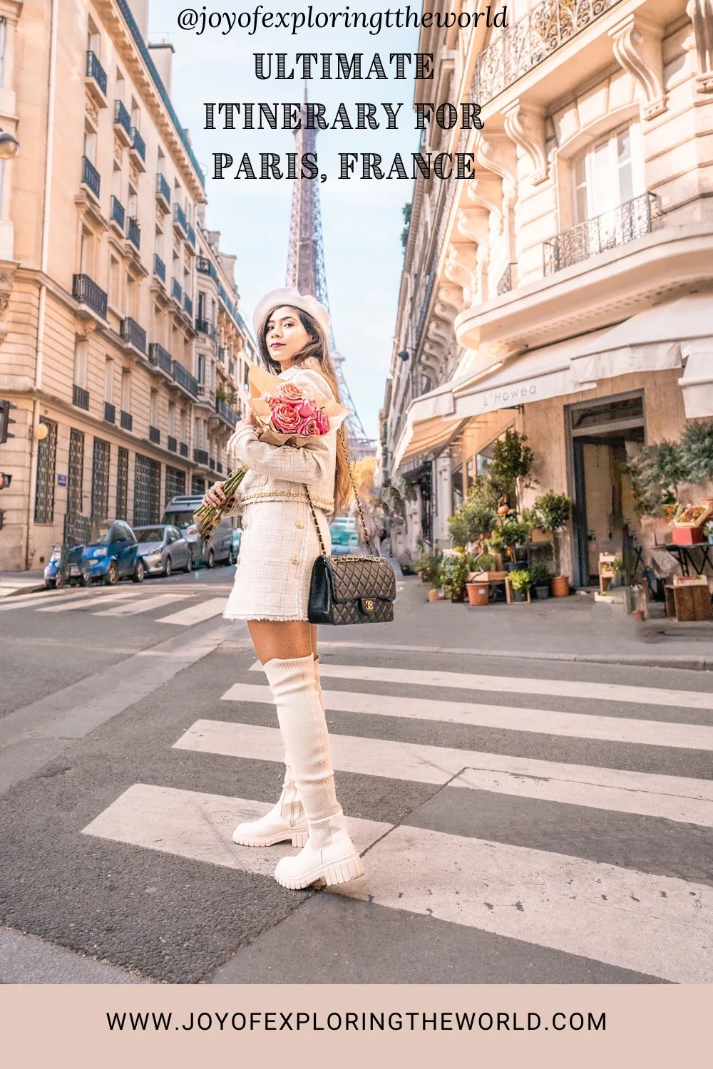 Young woman in a chic cream outfit holding roses on a Parisian street with the Eiffel Tower in the background.