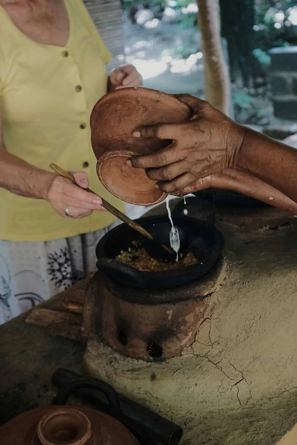 Pouring coconut milk into a pot