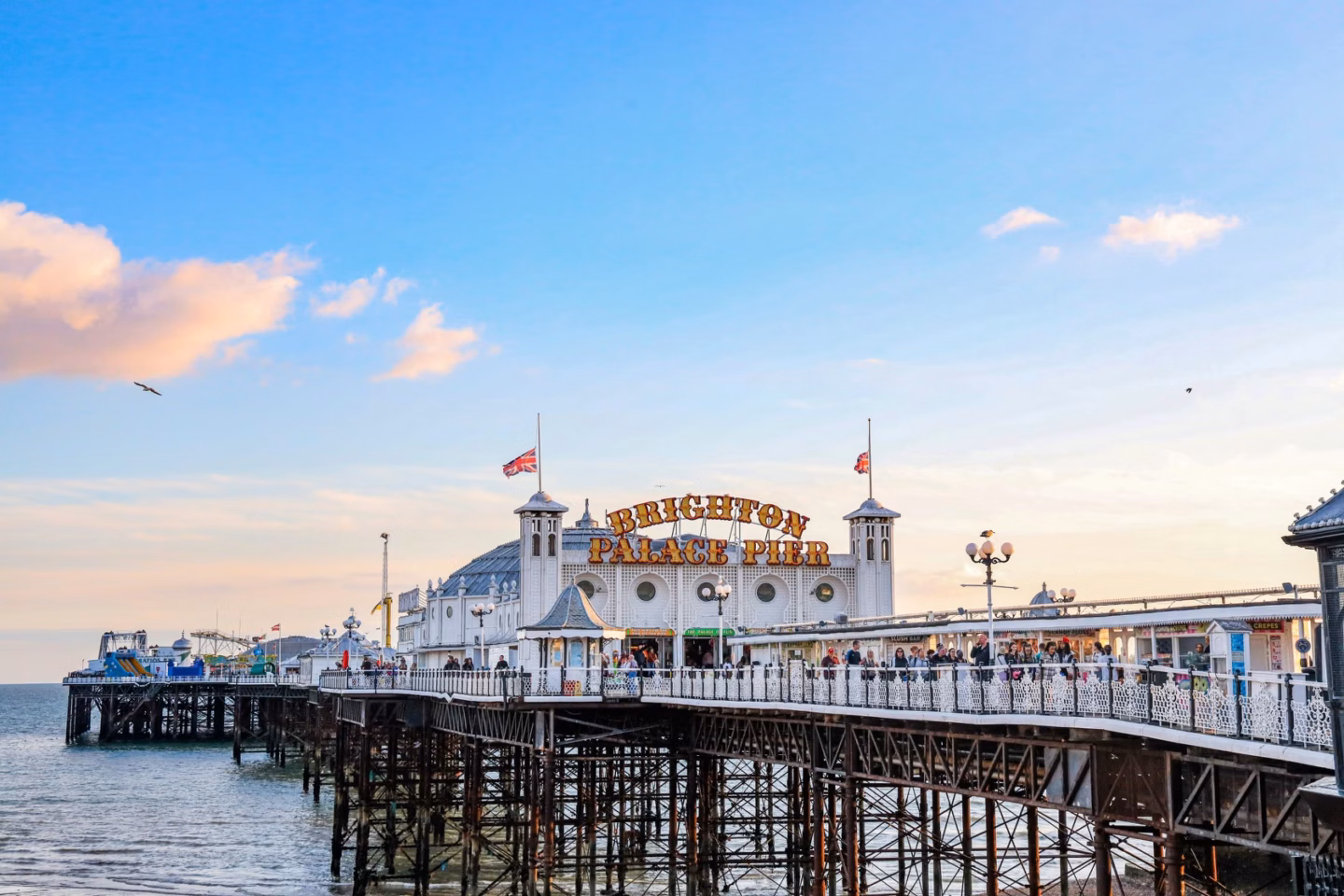 Brighton Palace Pier stretching over the sea under a blue sky at sunset