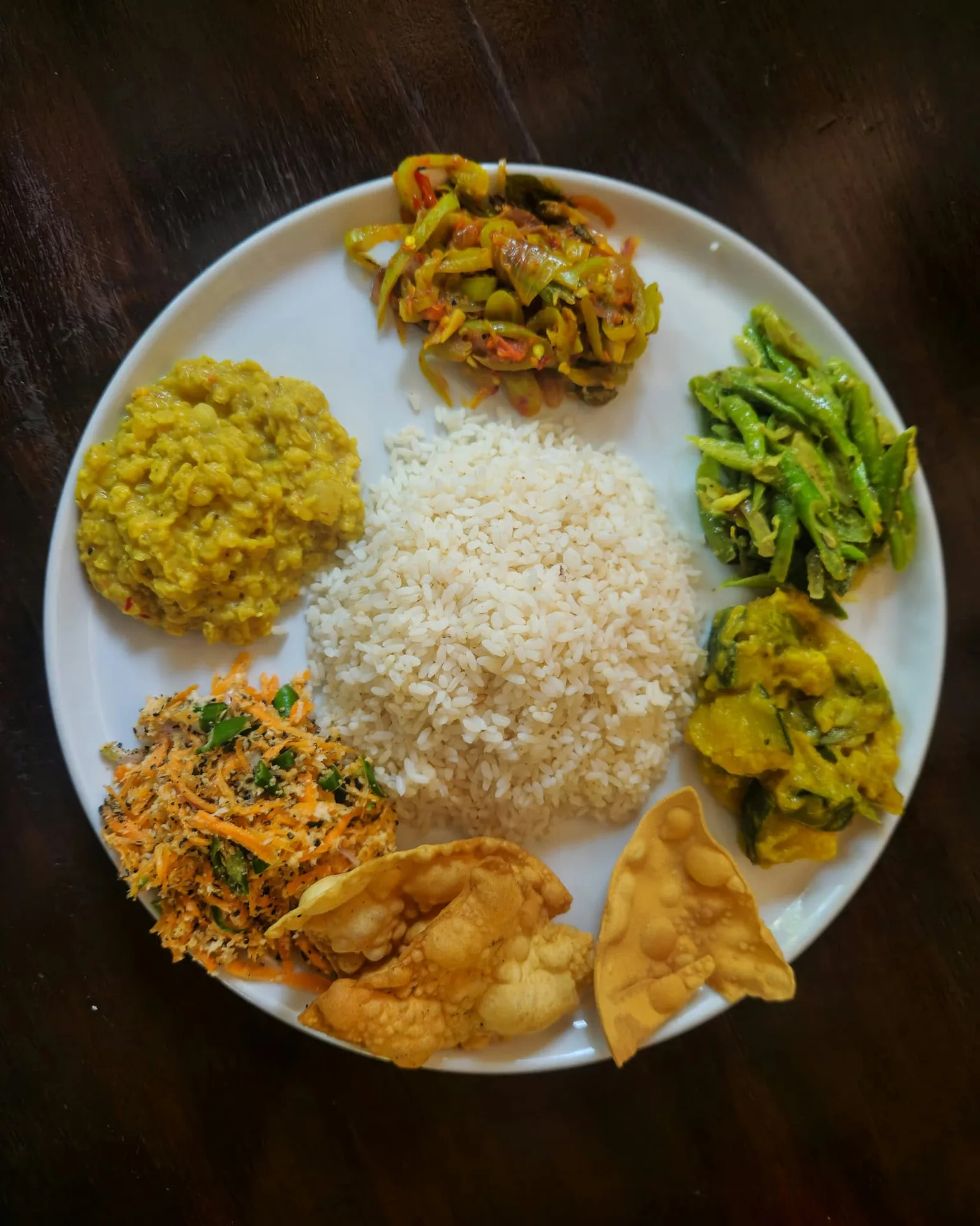 Sri Lankan rice and curry with dhal, chicken curry, and pol sambolate