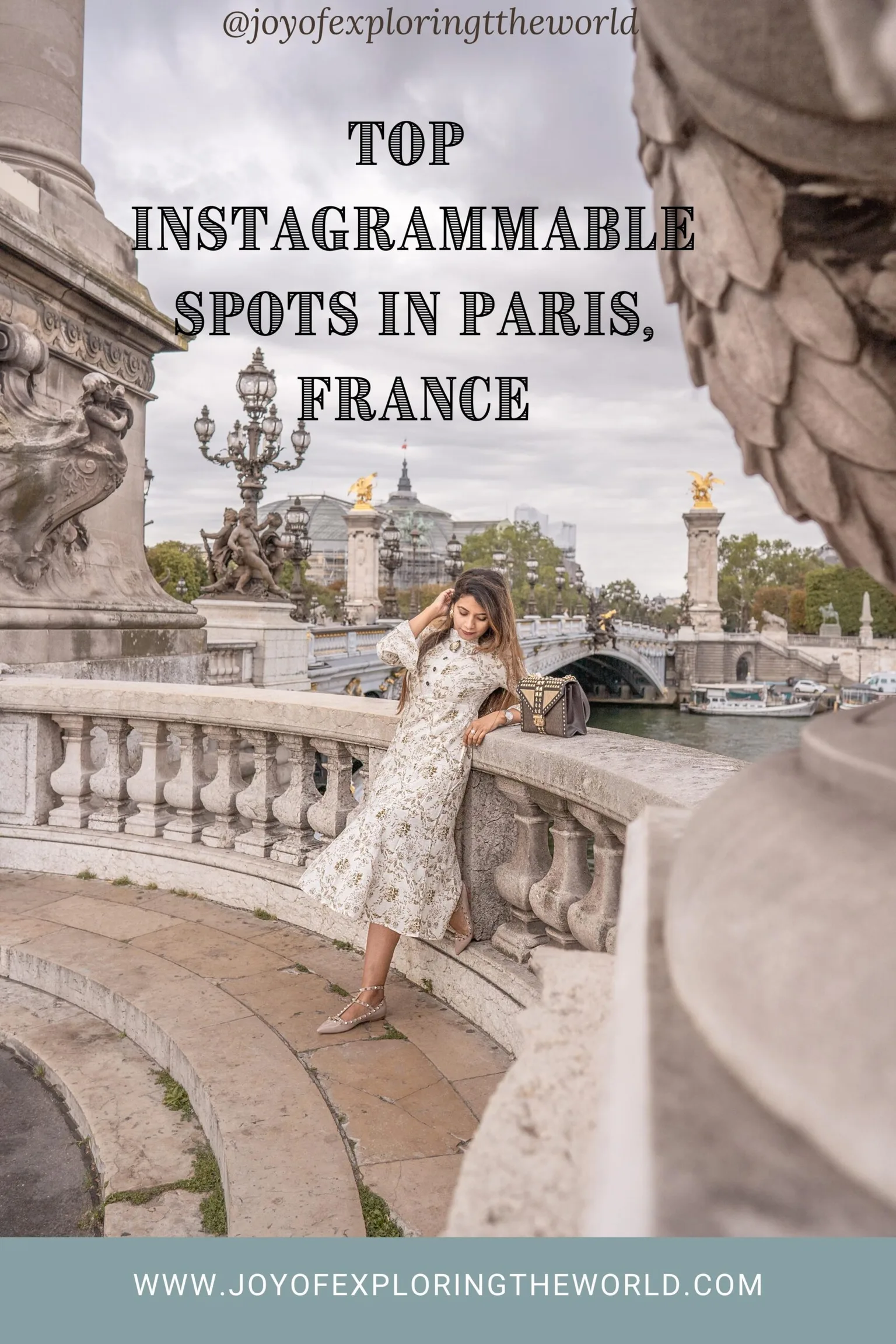 Woman in a floral dress leaning on the ornate stone balustrade of Pont Alexandre III with Parisian lamps and bridge in the background.