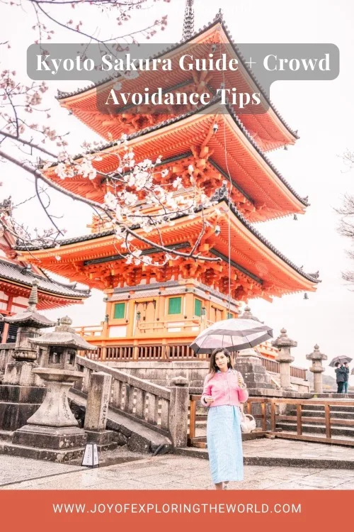 Woman with umbrella standing before a bright orange five-tier pagoda framed by cherry blossoms at a Kyoto temple, with blog title overlay and website bar visible